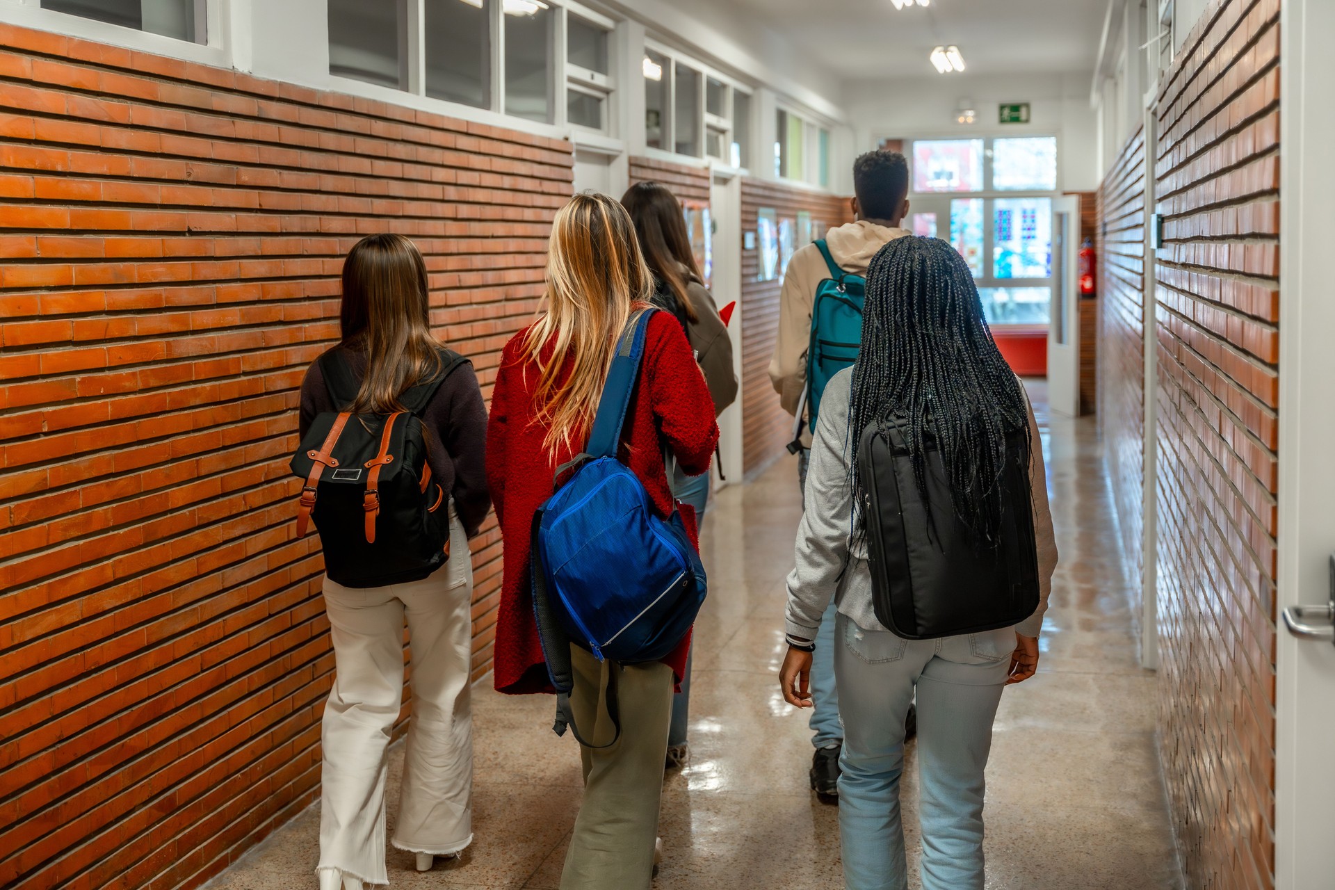 Students walking through school hallway